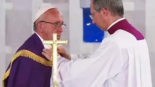 Mons. Marini helping the Holy Father change the vestment
