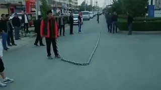 Guy Whipping a Massive Chain