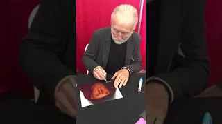 Tobin Bell signs a picture of him for me