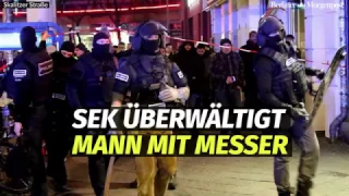 Mann schneidet sich in Supermarkt mit Messer in Hals