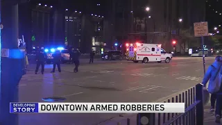 Woman dragged into street in string of armed robberies downtown; 3 men sought