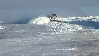 Plow truck clearing ice on the road to the diamond mines