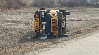 Police say a child was left pinned underneath a school bus rollover near Woodstock, Ont.