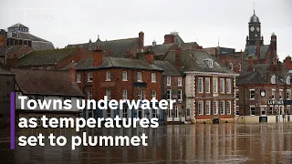 UK flooding: towns underwater as temperatures set to plummet