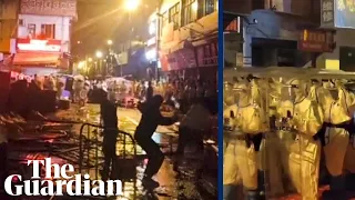 Protesters clash with hazmat suit-clad riot police in Guangzhou, China