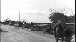 A convoy of German vehicles and motorcycles moves past a traffic barrier to come ...HD Stock Footage