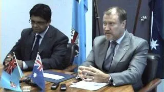 Fijian Attorney General Aiyaz Sayed-Khaiyum presents a cheque to the Australian Government