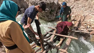 Watch this incredible nomadic family build a stunning stone and wood bridge from scratch!