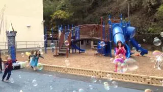 Kids chasing bubbles