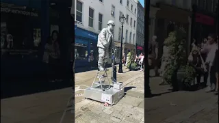 Silver man statue getting up , down and performing in under one minute! (Song by Silverman statue).