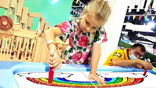 Diana and Roma interact with fun exhibits at the children's museum