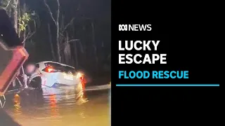 A driver is lucky to be alive after being rescued from floodwaters near Darwin | ABC News