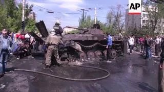 Burning barricades and charred wreckage of Ukrainian APC after clashes