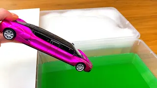 Diecast Cars Sliding Into the Green Water and Foam