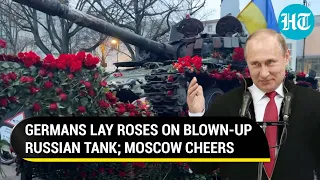 Putin cheers as Germans lay roses on blown-up Russian tank amid anti-West protest