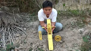 The boy searched for treasure in the wild and found a push saw made of pure gold