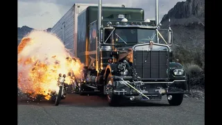 Kenworth K-100 chases Kenworth W-900