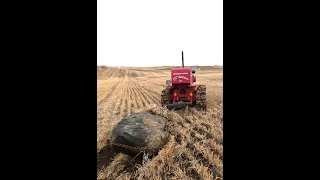 T6 International crawler pulls boulder