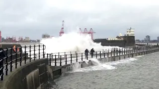 People hit by large waves on New Brighton seafront from Storm Ciara