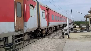 The Red Train crawls thru a Level crossing-Indian Railways YPR GKP Exp