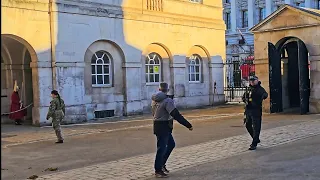 POLICE to idiot: THAT LINE, THAT SIDE! Tourist thinks he can visit the Guards and Horses!