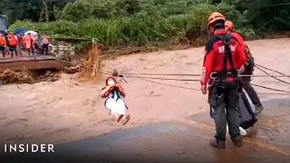 Monks Zipline Over Raging River To Escape Deadly Floods In Thailand | Insider News