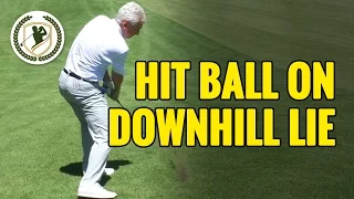 HOW TO HIT A GOLF BALL ON A DOWNHILL LIE