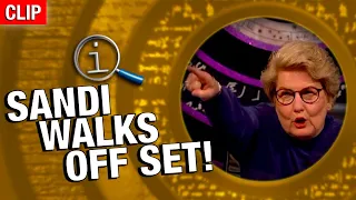 QI | Sandi Walks Off Set!