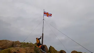 Raising Guernseys Independence Flag from Grosse rock !  Crab & Lobster Fishing