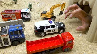 Police car rescue construction vehicles from the hand in the cave