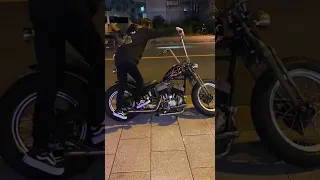 Biker girl kick starting her beautiful Harley-Davidson motorcycle