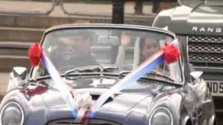 Prince William and Kate Middleton driving away from the reception in an Aston Martin