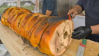 Italy Street Food. Cutting Huge Porchetta for Stuffed Sandwiches