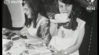 Siamese twins performing household tasks (1924)