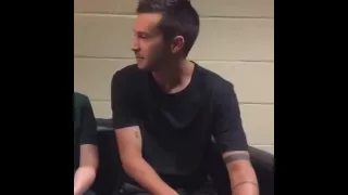 Tyler Joseph playing with his arms while smiling | to fake you out