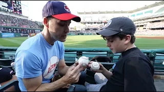 Helping a kid catch baseballs at Progressive Field