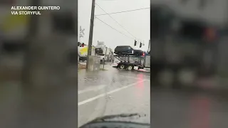 Video captures moment train slams into car hauler stuck on tracks