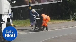 Lorry driver stops to help elderly woman cross busy road