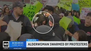 Alderwoman swarmed by protesters upset with migrant tent plan