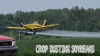 ARIEL FIELD SPRAYING CROP DUSTING A FIELD OF SOYBEANS.