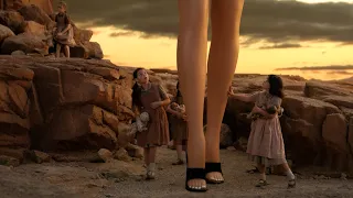 A group of children surrounding a pair of enormous feet.