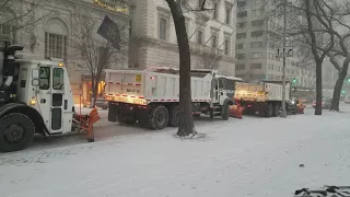 DSNY Snow Plows And Salt Spreaders Staging For Snow Removal During A NYC Blizzard