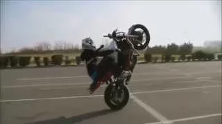 Девушка показывает трюки на мотоцикле. The girl shows stunts on a motorcycle.