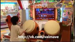 Japanese kid playing on Taiko drums in arcade