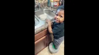 Semaj washing dishes