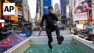 US Navy divers play underwater tic tac toe in Times Square