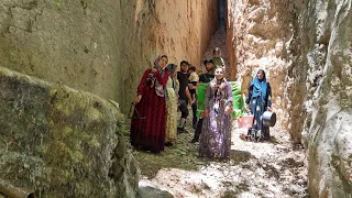 Journey of Tribal Family through Water-Filled Gorge with Challenging Passages