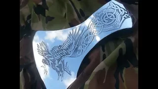 Drawing on metal. Shiny ax of the Vikings. Ax restoration and customization.