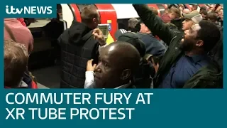 Commuters drag Extinction Rebellion protesters off Tube trains | ITV News