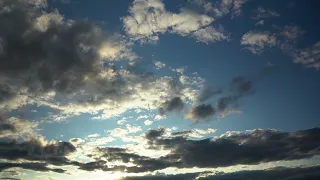 Amazing Movement of Clouds on the Blue Sky at the Fading Sunset